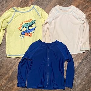 Set of 3 swim shirts/rash guards. Size 2T. Great condition